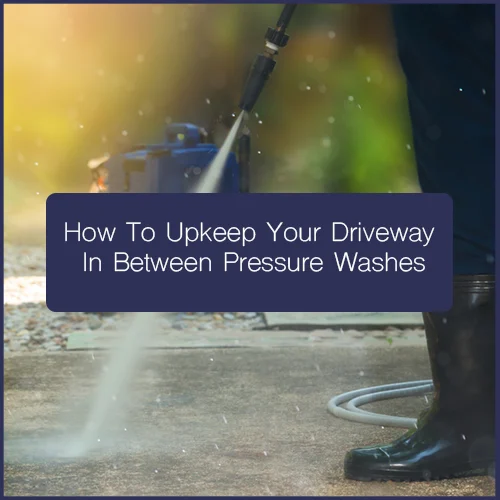 Worker using a surface cleaner on paving