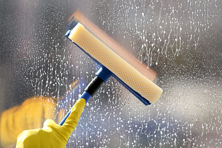 Cleaning a window with a squeegee