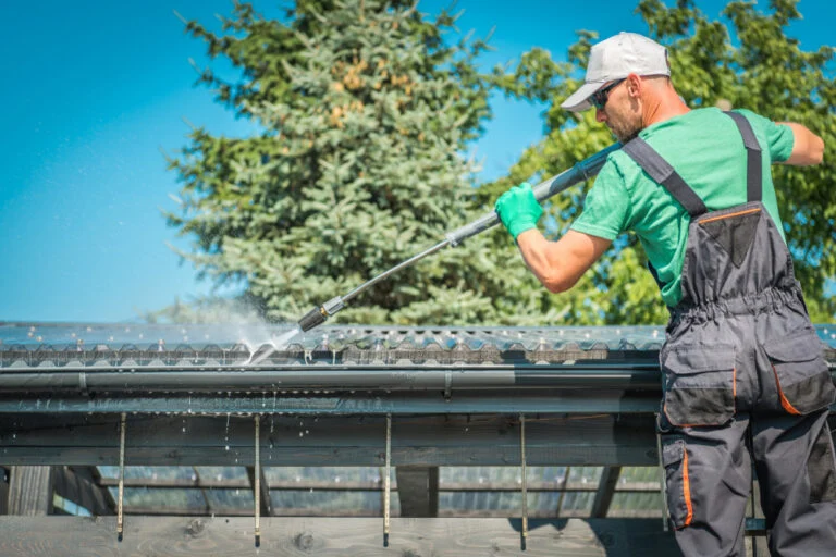 Worker cleaning a conservatory roof