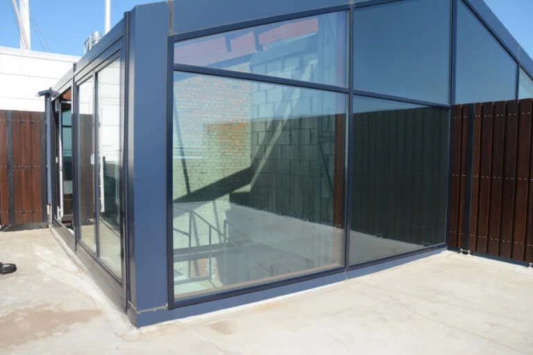 Modern glass extension with dark metal framing