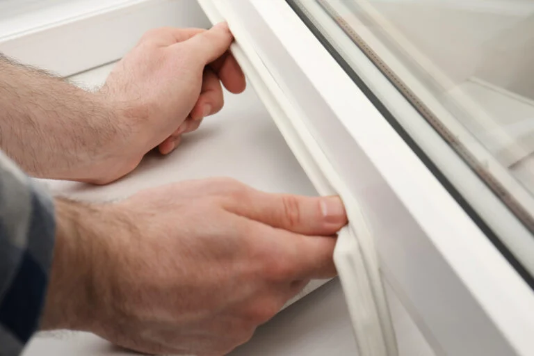Worker cleaning a UPVC window frame