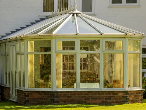 Traditional glazed conservatory adjoining a house