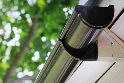 Gutter along the edge of a sloping roof