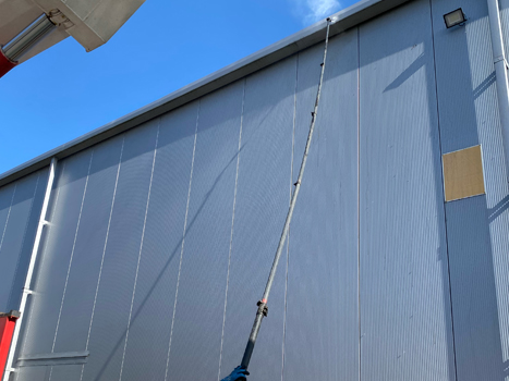 Cladding being soft washed by Just Clean Property Care