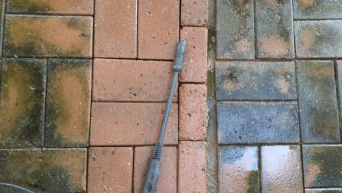 Weathered block paving with stained and clean sections