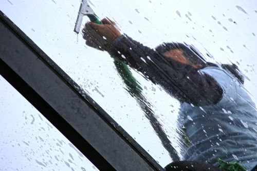 Worker cleaning a conservatory roof