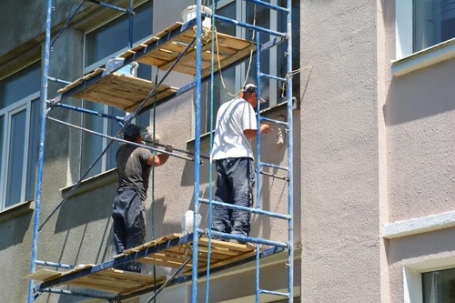 Commercial cladding being cleaned from an elevated platform