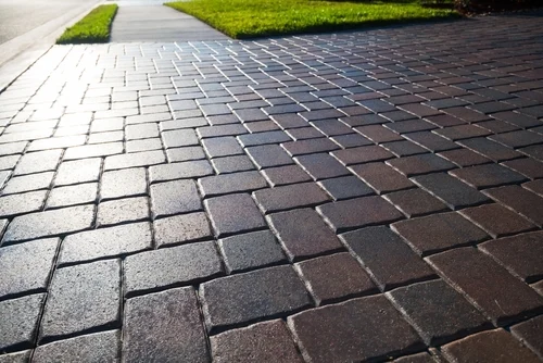 Clean block paving beside a lawn