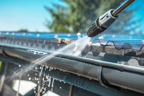 Worker cleaning a conservatory roof