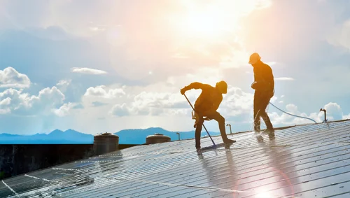 Two workers on a flat roof