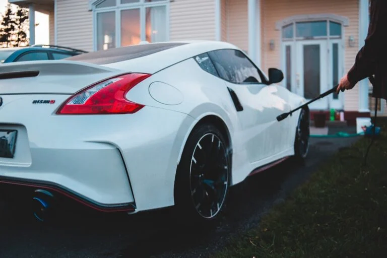 Electric car connected to a charging point outside a house