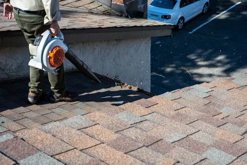 Worker using a surface cleaner on paving