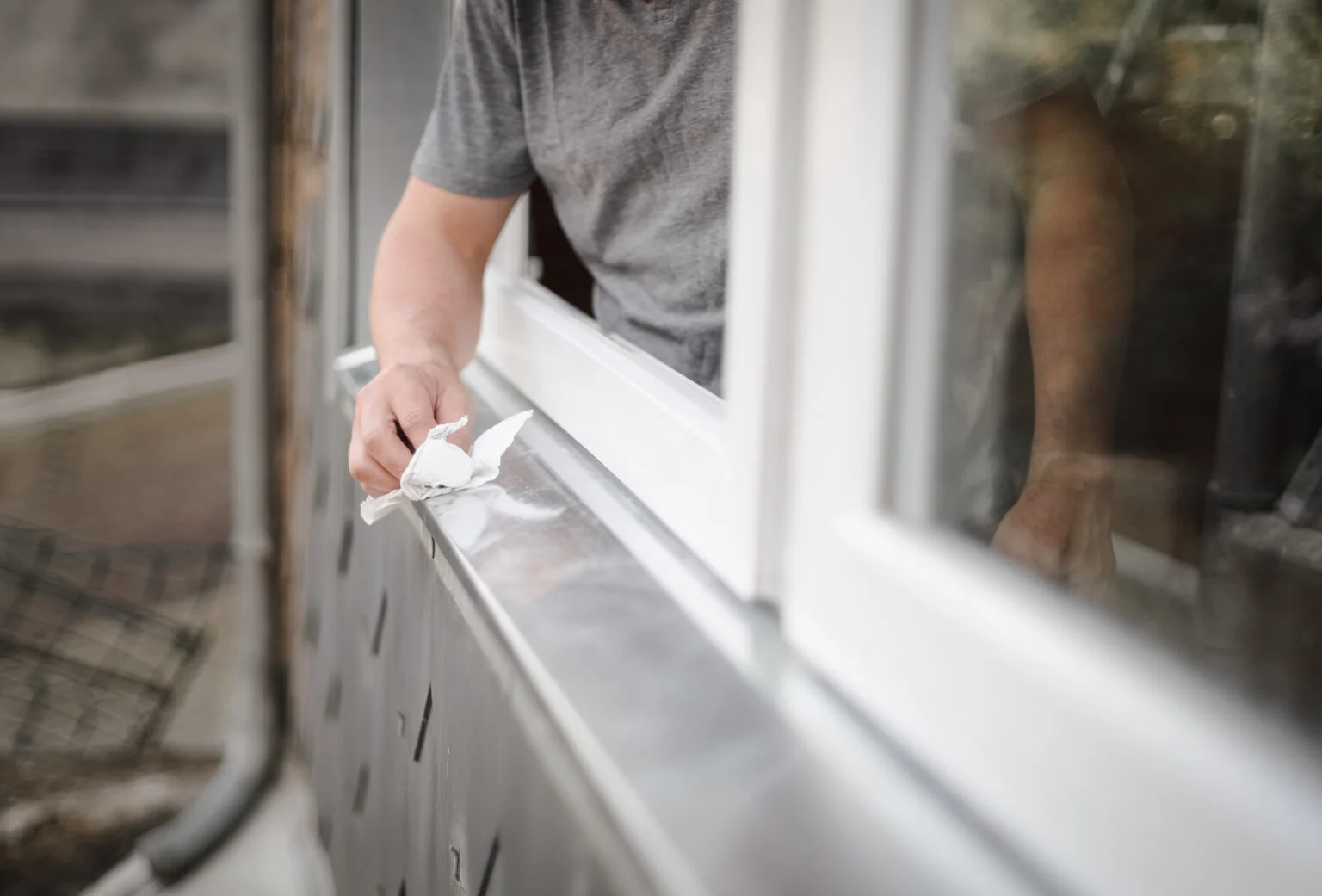 Worker cleaning a window frame